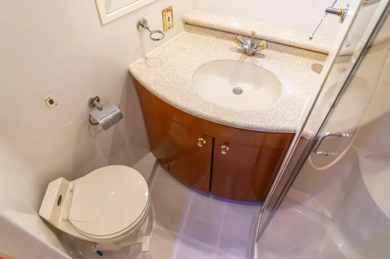 Slide: The Image of Bathroom interior of 2000 Carver 450 Voyager Pilothouse yacht, featuring sink and toilet. - 62