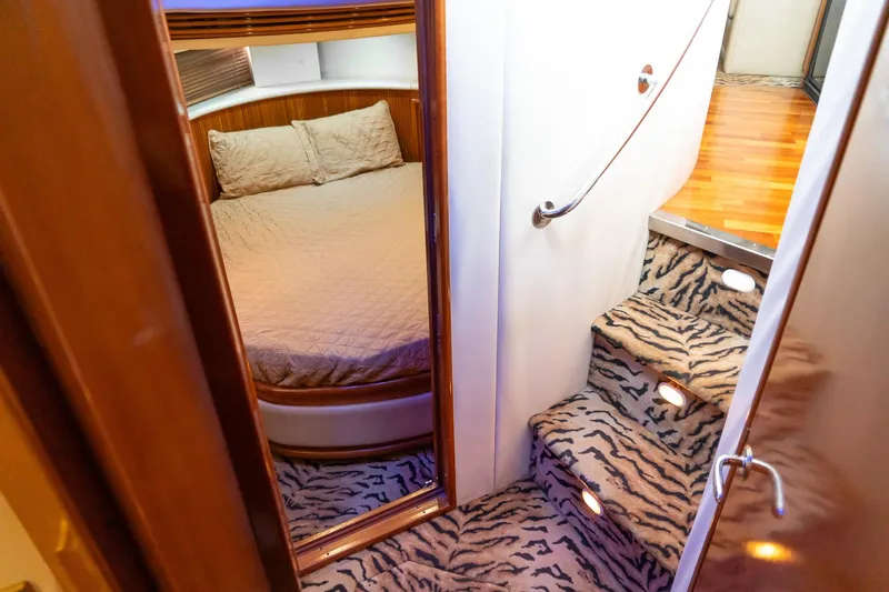 Slide: The Image of Interior of 2000 Carver 450 Voyager Pilothouse with zebra-patterned stairs and cozy bedroom. - 63