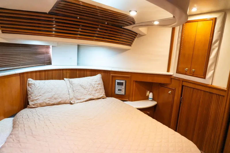 Slide: The Image of Luxurious bedroom interior of 2000 Carver 450 Voyager Pilothouse yacht with wood accents. - 65