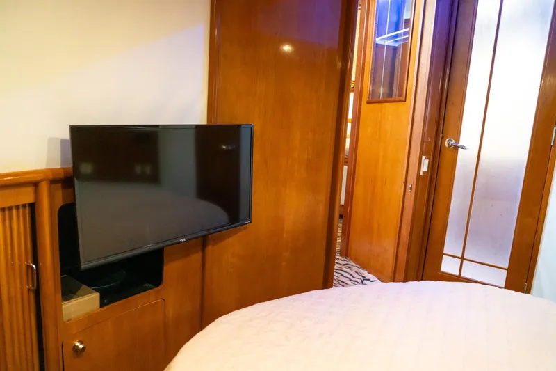 Slide: The Image of Interior of 2000 Carver 450 Voyager Pilothouse with TV and wooden furnishings. - 66