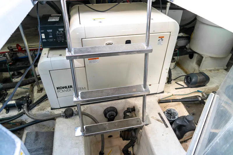 Slide: The Image of Engine room of 2000 Carver 450 Voyager Pilothouse with Kohler power system and ladder. - 73