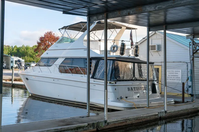 Slide: The Image of 2000 Carver 450 Voyager Pilothouse yacht docked at marina under shelter. - 10
