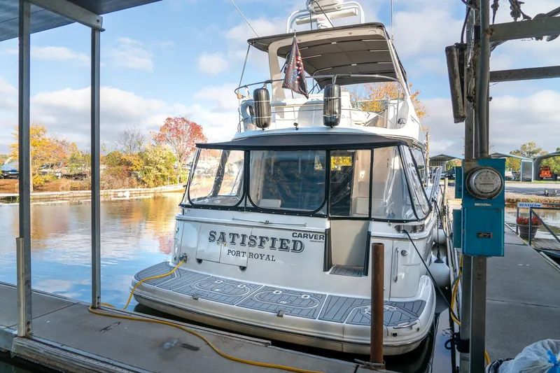 Slide: The Image of Carver 450 Voyager Pilothouse 2000 docked at marina with autumn trees in background. - 11