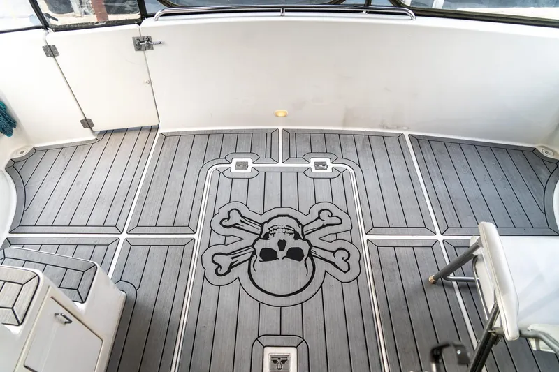 Slide: The Image of 2000 Carver 450 Voyager Pilothouse deck with skull and crossbones design. - 16