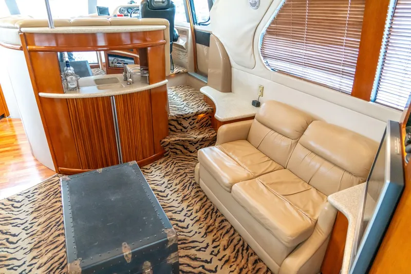Slide: The Image of Interior of 2000 Carver 450 Voyager Pilothouse with leather seating and zebra-patterned carpet. - 32