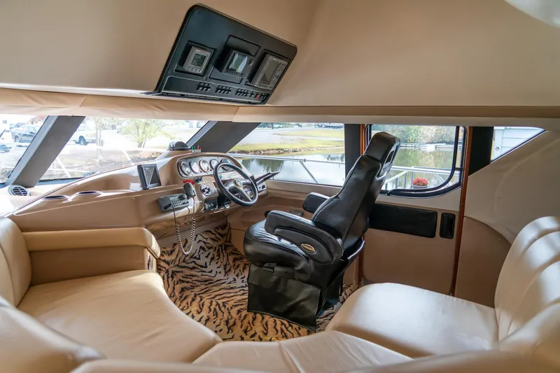 Slide: The Image of Interior of 2000 Carver 450 Voyager Pilothouse with leather seating and zebra-patterned carpet. - 35