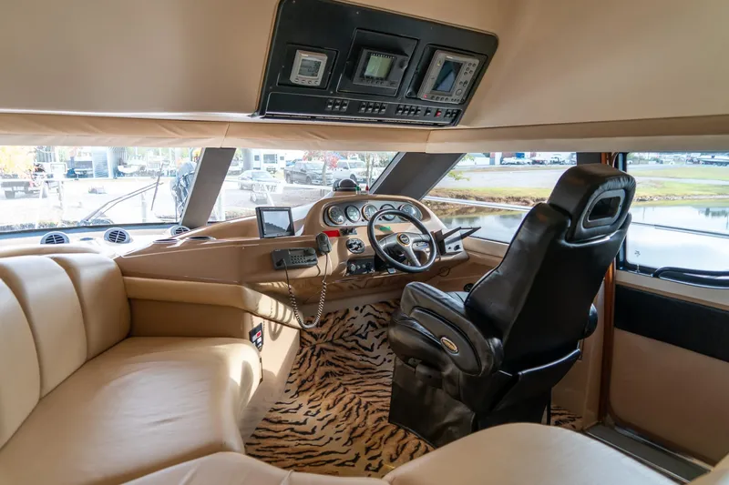 Slide: The Image of Interior of 2000 Carver 450 Voyager Pilothouse with leather seating and zebra-patterned carpet. - 36