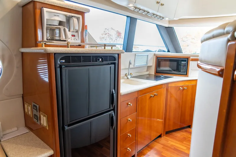 Slide: The Image of Luxurious kitchen in 2000 Carver 450 Voyager Pilothouse with appliances and wood cabinetry. - 47