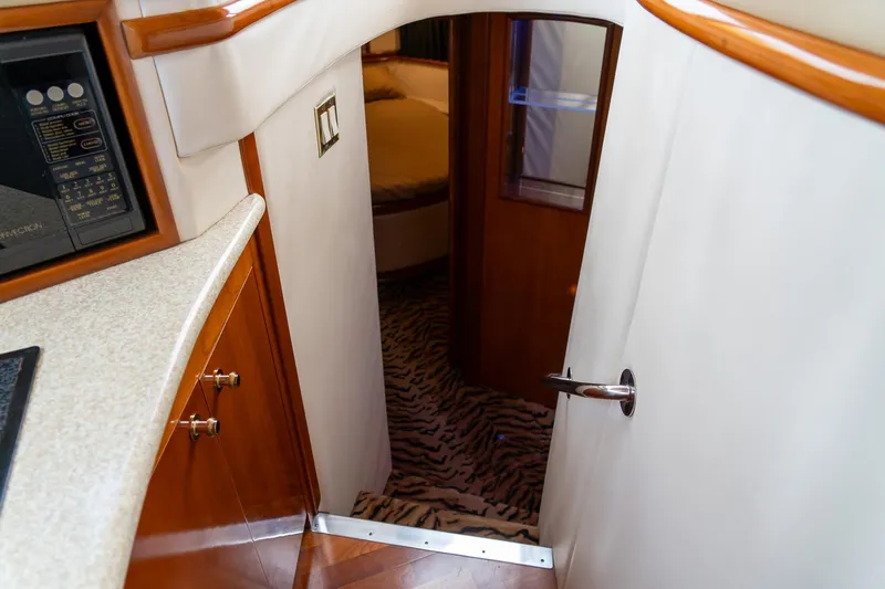 Slide: The Image of Interior of 2000 Carver 450 Voyager Pilothouse with wood accents and patterned carpet. - 56