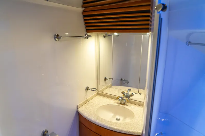 Slide: The Image of Bathroom vanity in 2000 Carver 450 Voyager Pilothouse yacht, featuring a sink and mirror. - 68