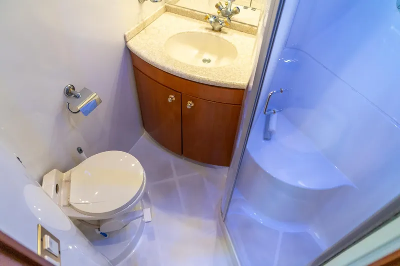 Slide: The Image of Compact bathroom in 2000 Carver 450 Voyager Pilothouse with shower, sink, and toilet. - 69