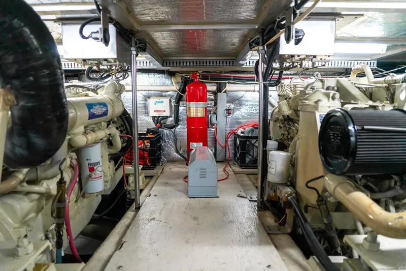Slide: The Image of Engine room of 2000 Carver 450 Voyager Pilothouse with machinery and fire extinguisher. - 70