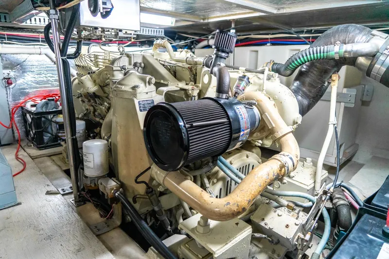 Slide: The Image of Engine room of a 2000 Carver 450 Voyager Pilothouse yacht, showcasing mechanical components. - 72