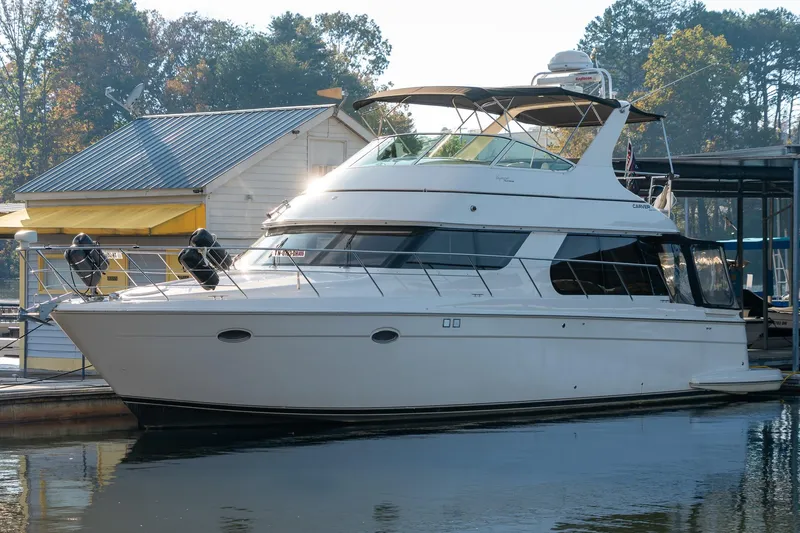 Slide: The Image of 2000 Carver 450 Voyager Pilothouse yacht docked at marina, sunny day. - 8