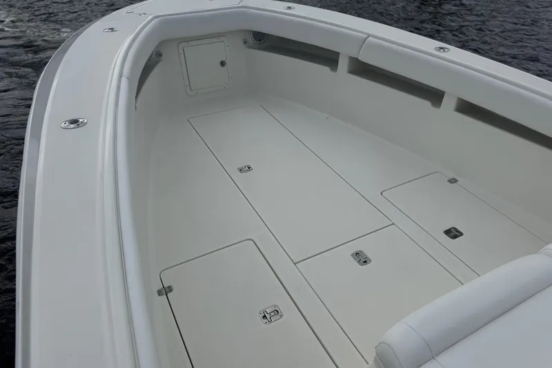 Slide: The Image of 2013 SeaVee 320B boat deck with storage compartments on calm water. - 11