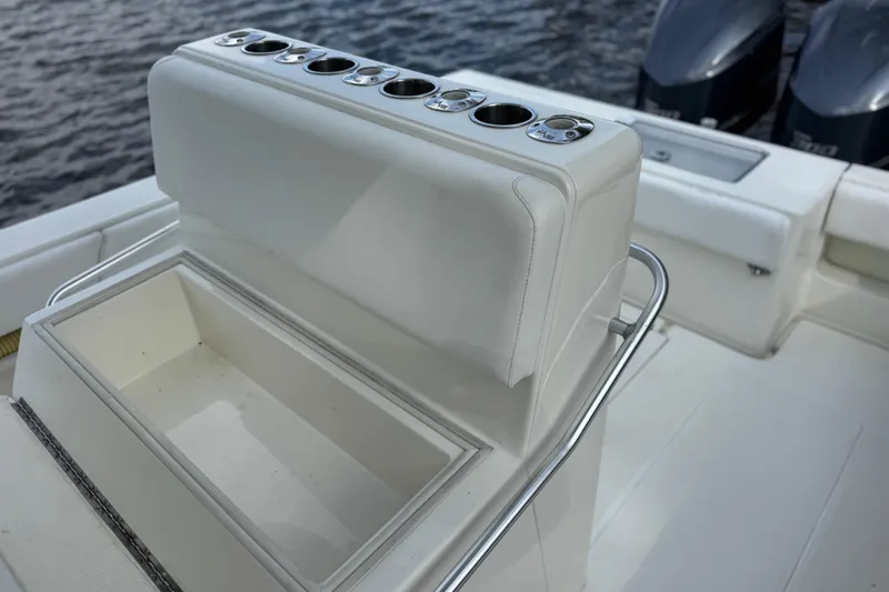 Slide: The Image of 2013 SeaVee 320B boat interior with rod holders and storage compartment, docked on water. - 21