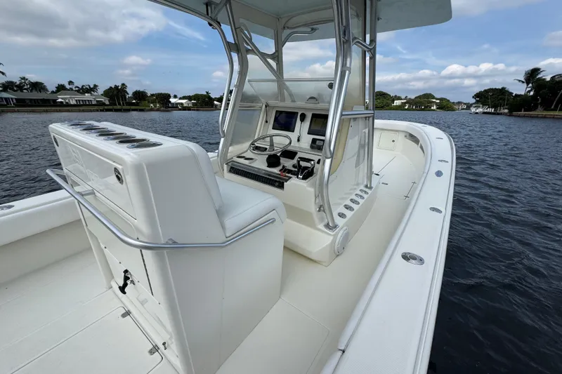 Slide: The Image of 2013 SeaVee 320B boat on water, featuring a sleek console and spacious deck. - 23
