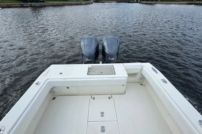 Slide: The Image of 2013 SeaVee 320B boat with dual 300 horsepower engines on calm water. - 25