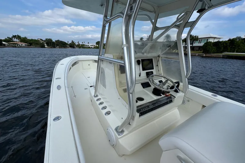 Slide: The Image of 2013 SeaVee 320B boat interior with steering console on calm water. - 26
