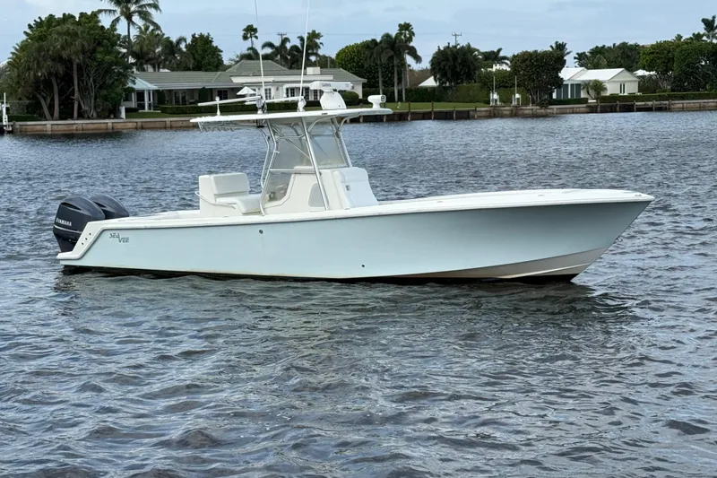 Slide: The Image of 2013 SeaVee 320B boat on calm water, featuring twin outboard engines. - 3