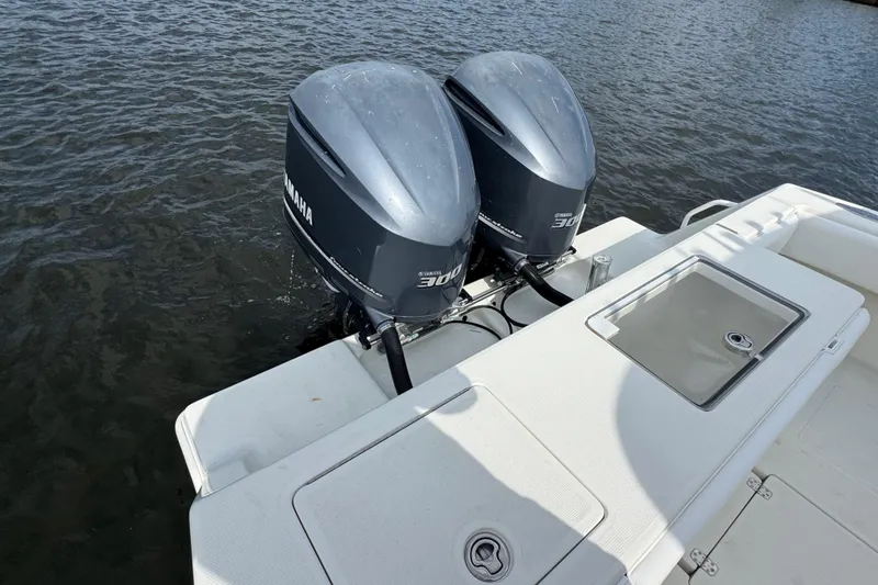 Slide: The Image of Twin Yamaha 300 engines on a 2013 SeaVee 320B boat, docked on water. - 31