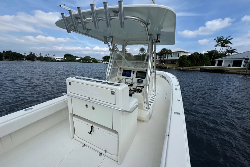 Slide: The Image of 2013 SeaVee 320B boat on water, featuring a sleek console and rod holders. - 32