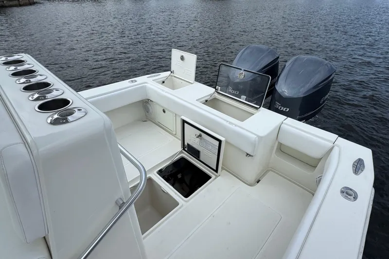 Slide: The Image of 2013 SeaVee 320B boat with twin engines and spacious deck on the water. - 33