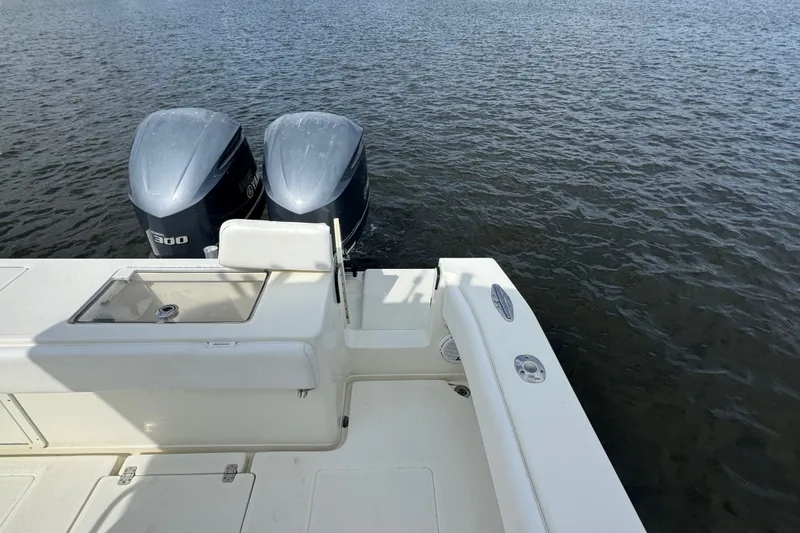 Slide: The Image of 2013 SeaVee 320B boat with dual outboard engines on calm water. - 34