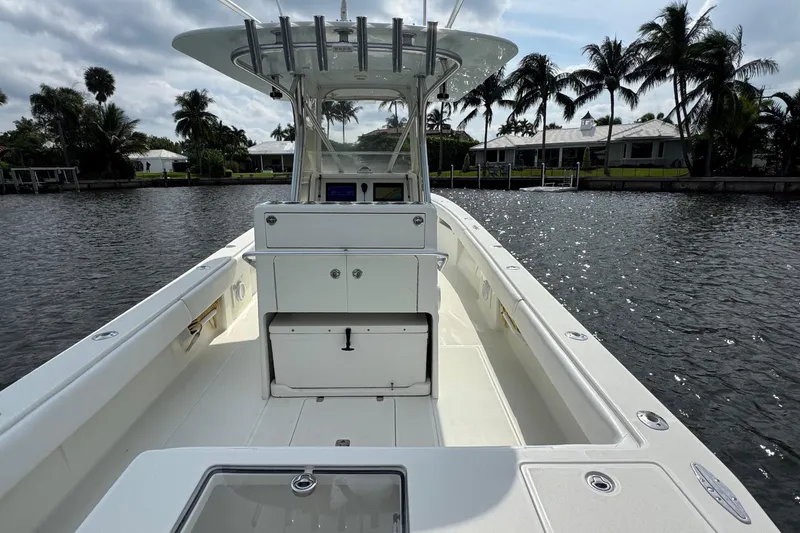 Slide: The Image of 2013 SeaVee 320B boat on calm water, surrounded by palm trees and waterfront homes. - 35