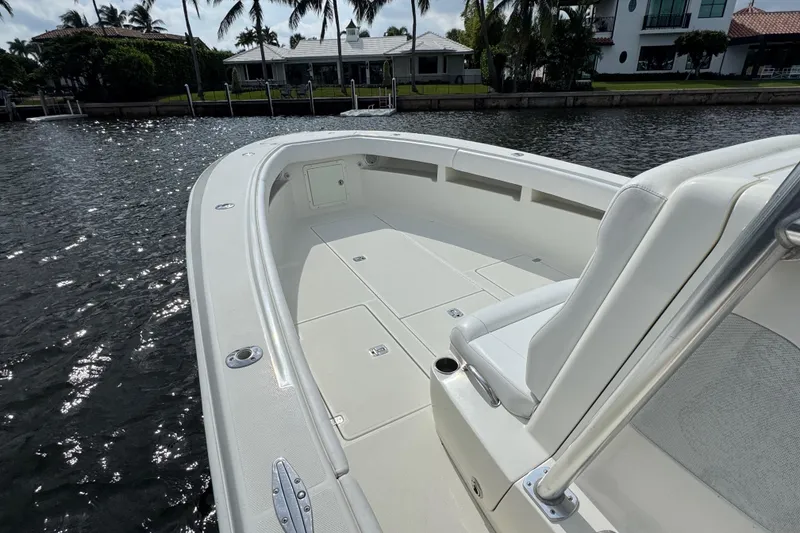 Slide: The Image of 2013 SeaVee 320B boat with spacious deck, docked by waterfront homes. - 4
