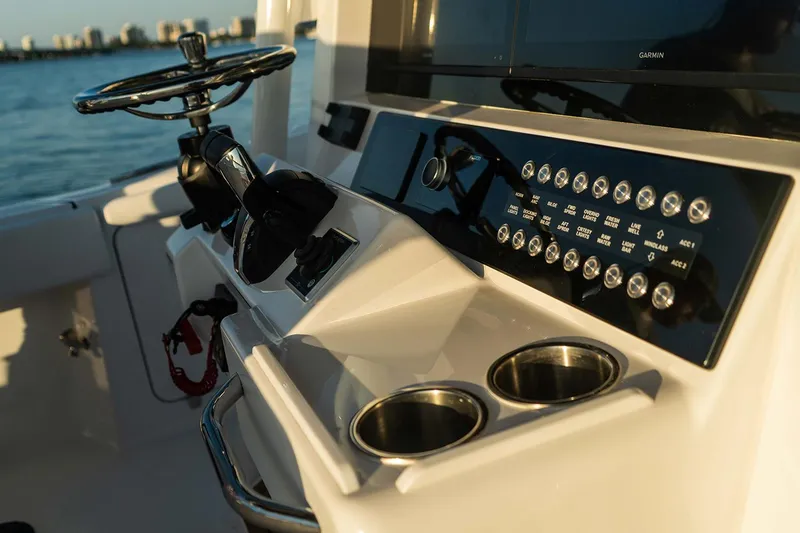 Slide: The Image of Manufacturer Provided Image: Helm of 2025 Southport 33 FE boat with steering wheel and control panel. - 4