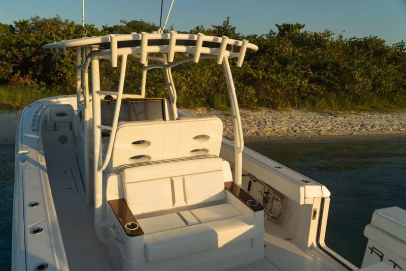 Slide: The Image of Manufacturer Provided Image: 2025 Southport 33 FE boat with seating, docked near a sandy beach. - 8