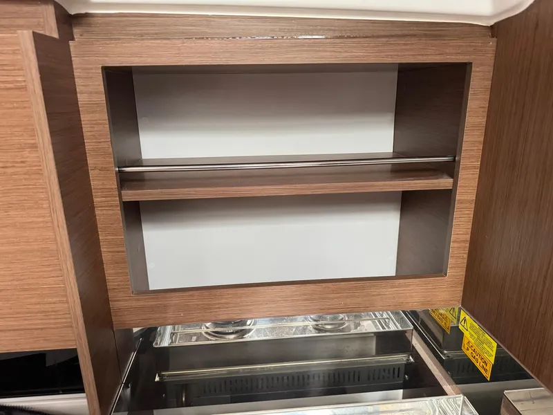 Slide: The Image of 2024 Beneteau Oceanis 34.1 interior wooden cabinet with shelf and modern design. - 12