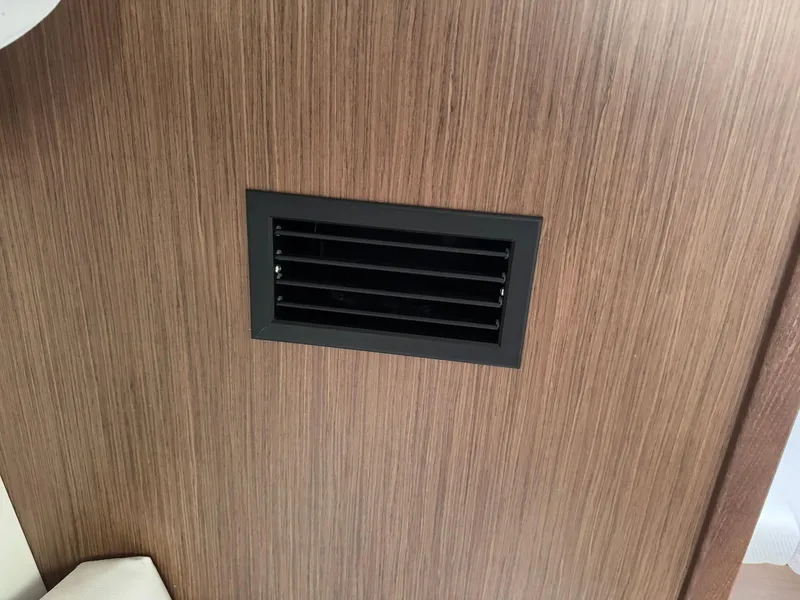 Slide: The Image of Vent on wooden panel inside 2024 Beneteau Oceanis 34.1 yacht. - 14