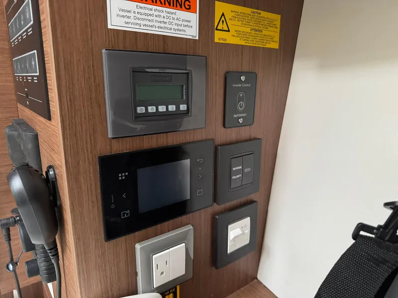 Slide: The Image of Control panel of a 2024 Beneteau Oceanis 34.1 yacht, featuring various switches and displays. - 19