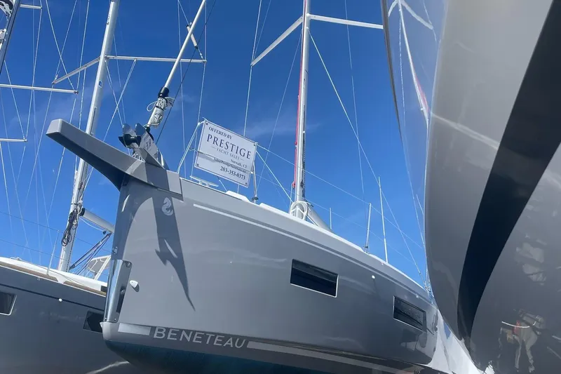 Slide: The Image of 2024 Beneteau Oceanis 34.1 sailboat docked under clear blue sky. - 2