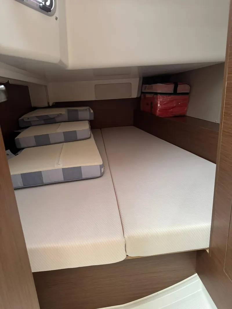 Slide: The Image of 2024 Beneteau Oceanis 34.1 cabin interior with neatly arranged bedding. - 20
