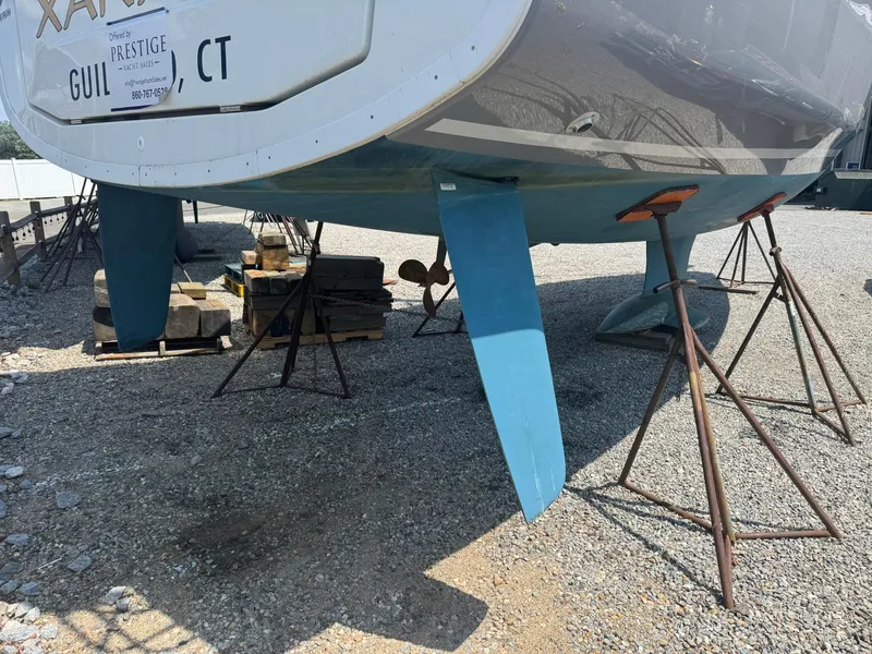 Slide: The Image of 2024 Beneteau Oceanis 34.1 sailboat on stands, displayed outdoors. - 26