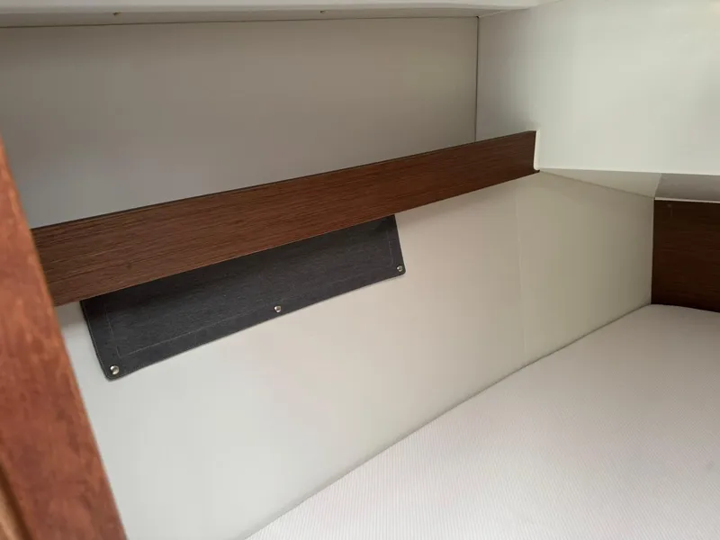 Slide: The Image of Interior cabin of 2024 Beneteau Oceanis 34.1 sailboat, featuring sleek wood and fabric design. - 7