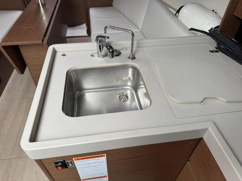 Slide: The Image of 2024 Beneteau Oceanis 34.1 yacht interior with modern kitchen sink and faucet. - 9
