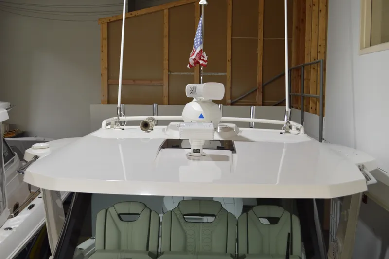 Slide: The Image of 2024 Tiara Yachts 34 LS boat with radar and American flag in a storage facility. - 16