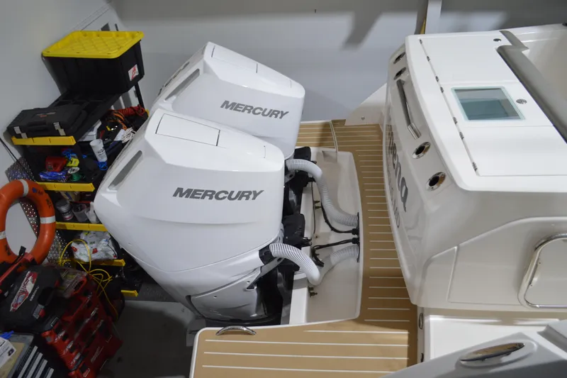 Slide: The Image of 2024 Tiara Yachts 34 LS with dual Mercury outboard engines in a garage setting. - 25