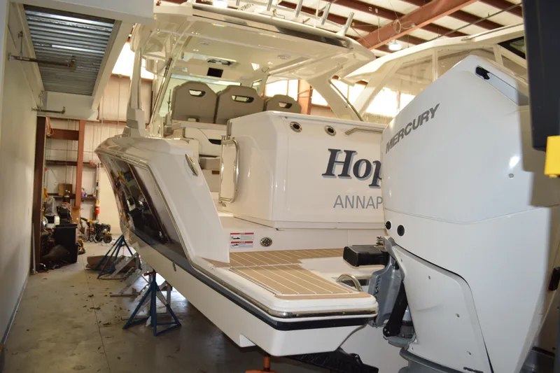 Slide: The Image of 2024 Tiara Yachts 34 LS in a storage facility, featuring Mercury outboard engine. - 3