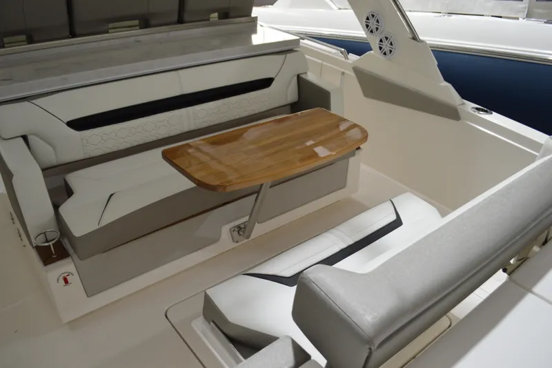 Slide: The Image of 2024 Tiara Yachts 34 LS interior with elegant seating and wooden table. - 30