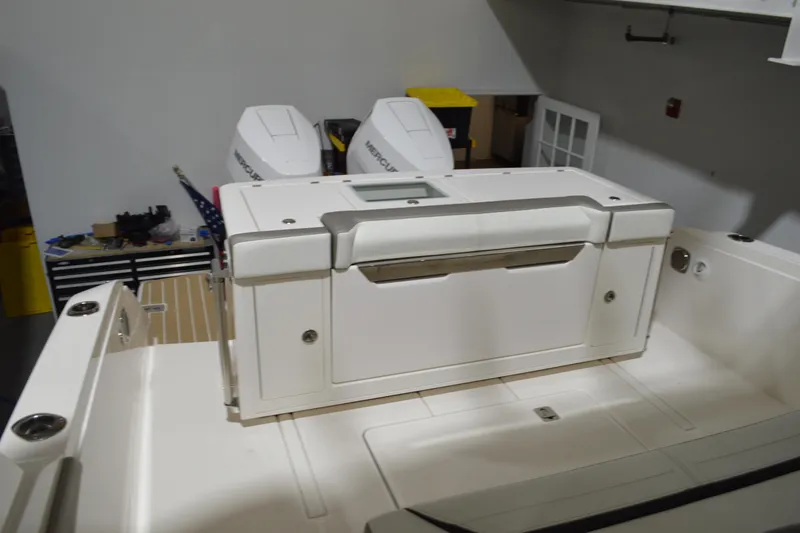 Slide: The Image of 2024 Tiara Yachts 34 LS boat interior with dual Mercury engines in a workshop setting. - 34