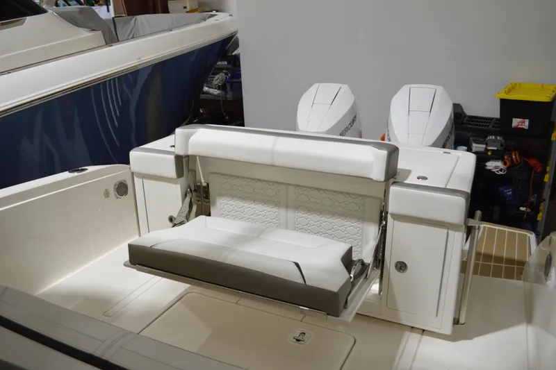 Slide: The Image of 2024 Tiara Yachts 34 LS with luxurious seating and dual outboard engines. - 36