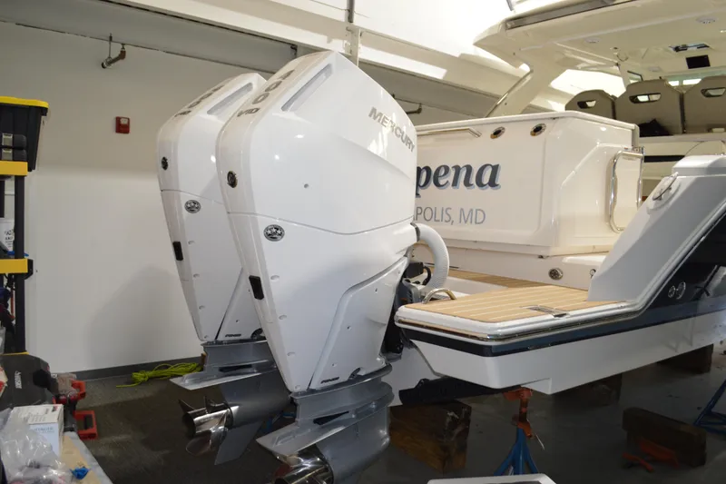 Slide: The Image of 2024 Tiara Yachts 34 LS with dual Mercury outboard engines in a showroom. - 4