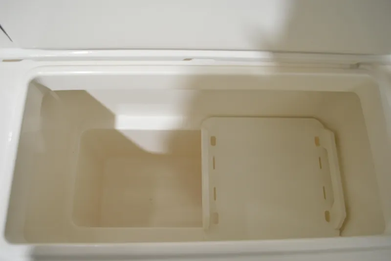 Slide: The Image of Open storage compartment in 2024 Tiara Yachts 34 LS, featuring a removable divider. - 44