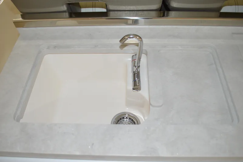 Slide: The Image of 2024 Tiara Yachts 34 LS sink with modern faucet and sleek countertop design. - 49