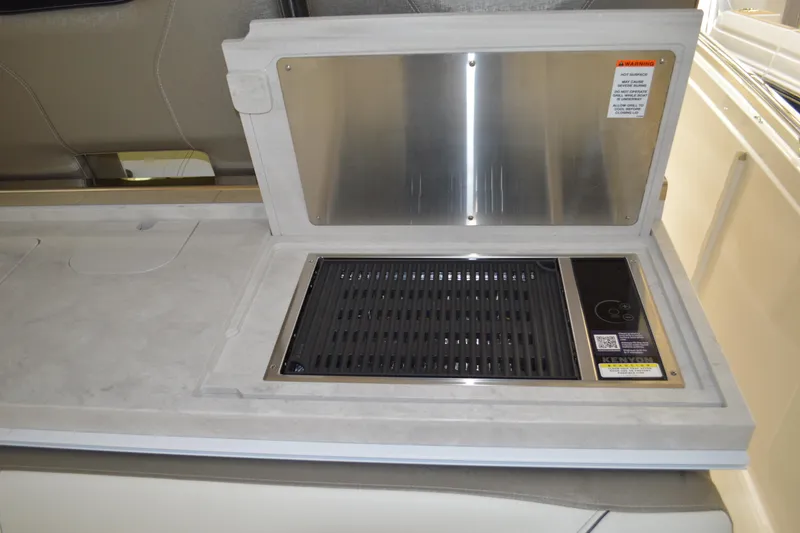 Slide: The Image of 2024 Tiara Yachts 34 LS grill station with stainless steel cover and integrated controls. - 50